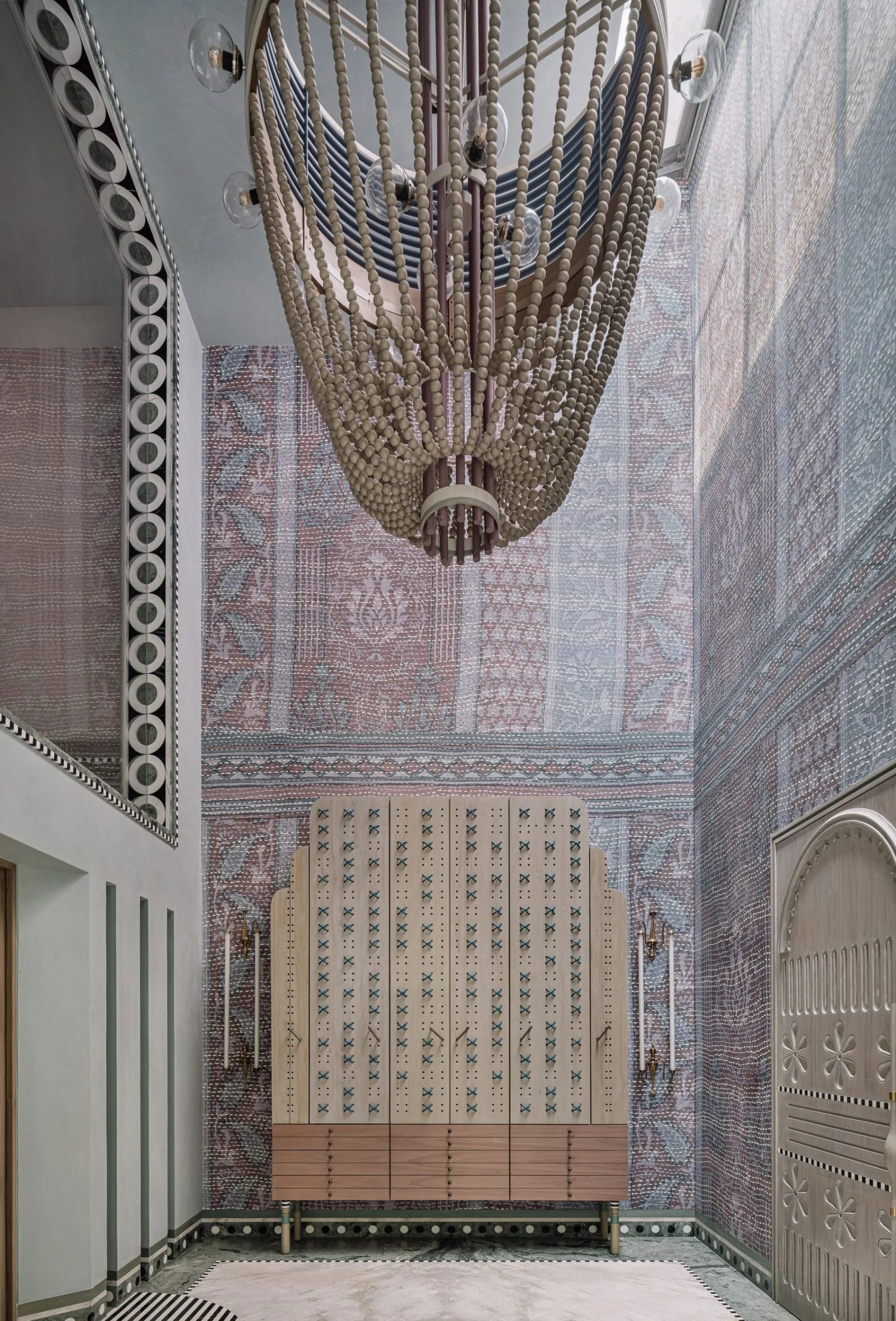 Large chandelier in hallway with purple walls