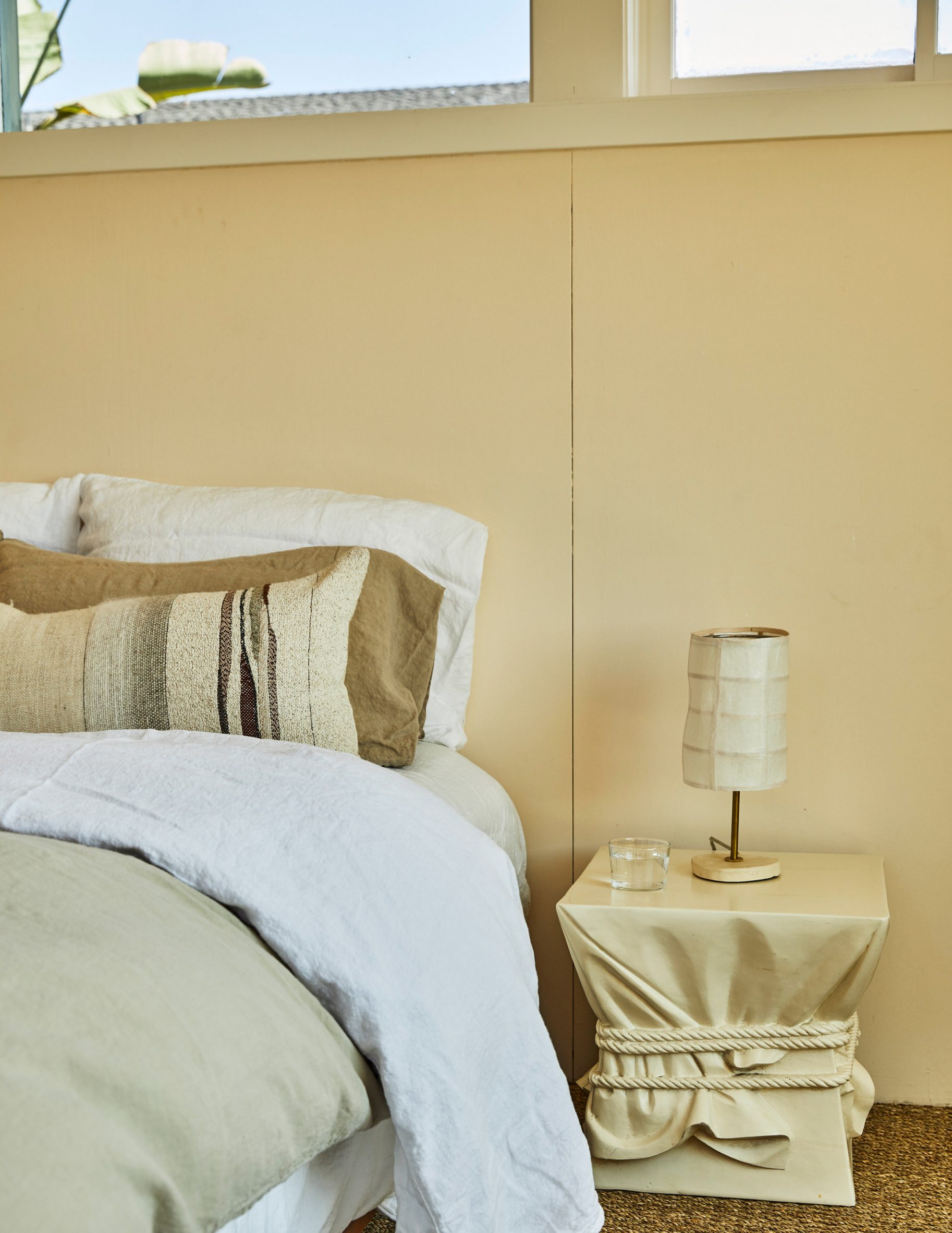 Butter-yellow wall complements the neutral tones