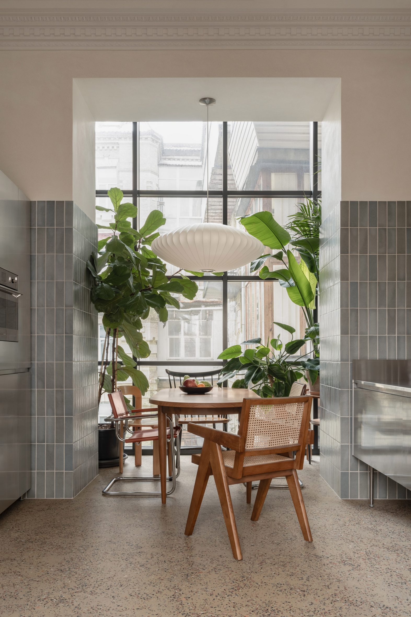 Dining space with mismatched chairs and house plants