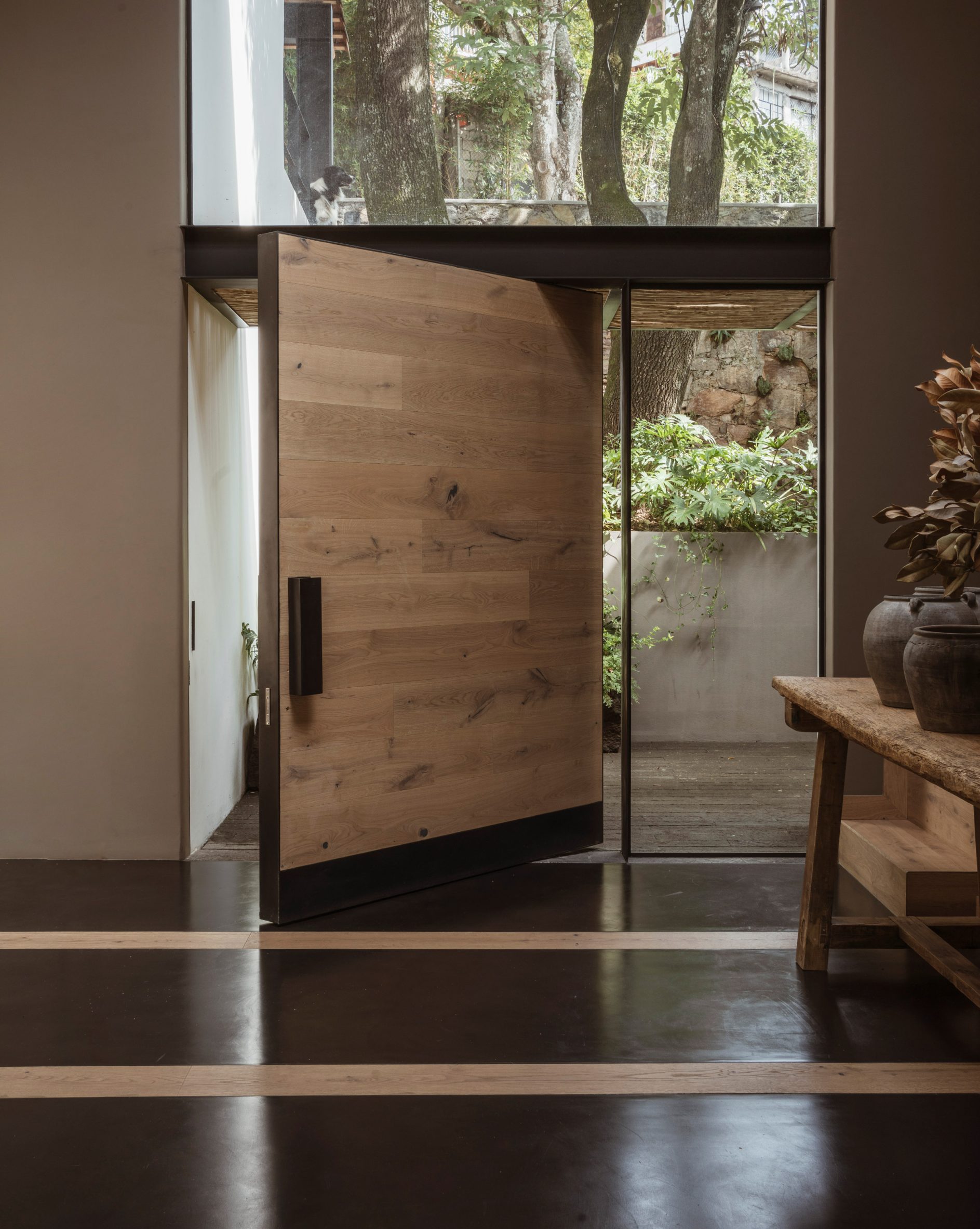 Pivoting door, Casa Tres Árboles in Valle de Bravo by Direccion