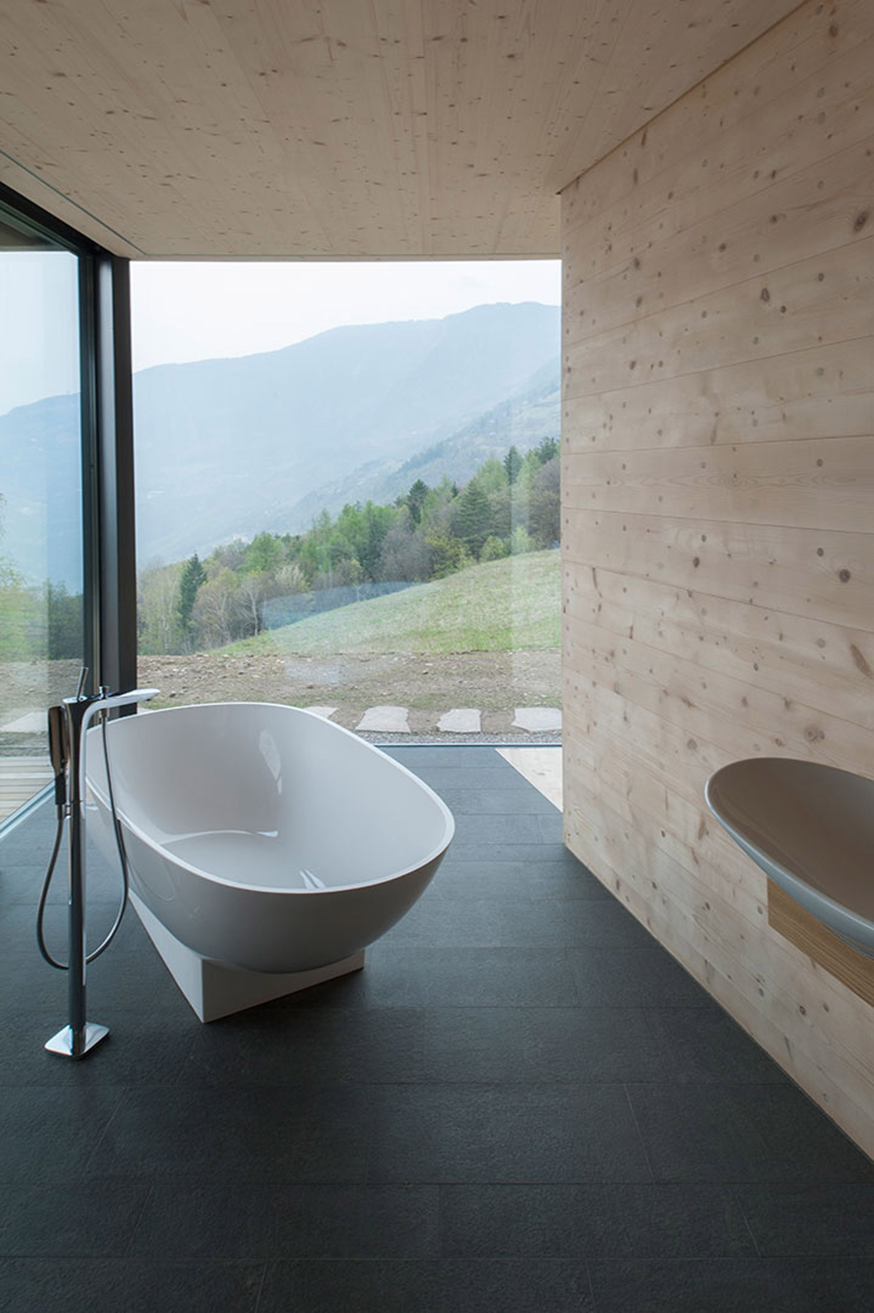 Bath in bathroom with glass walls