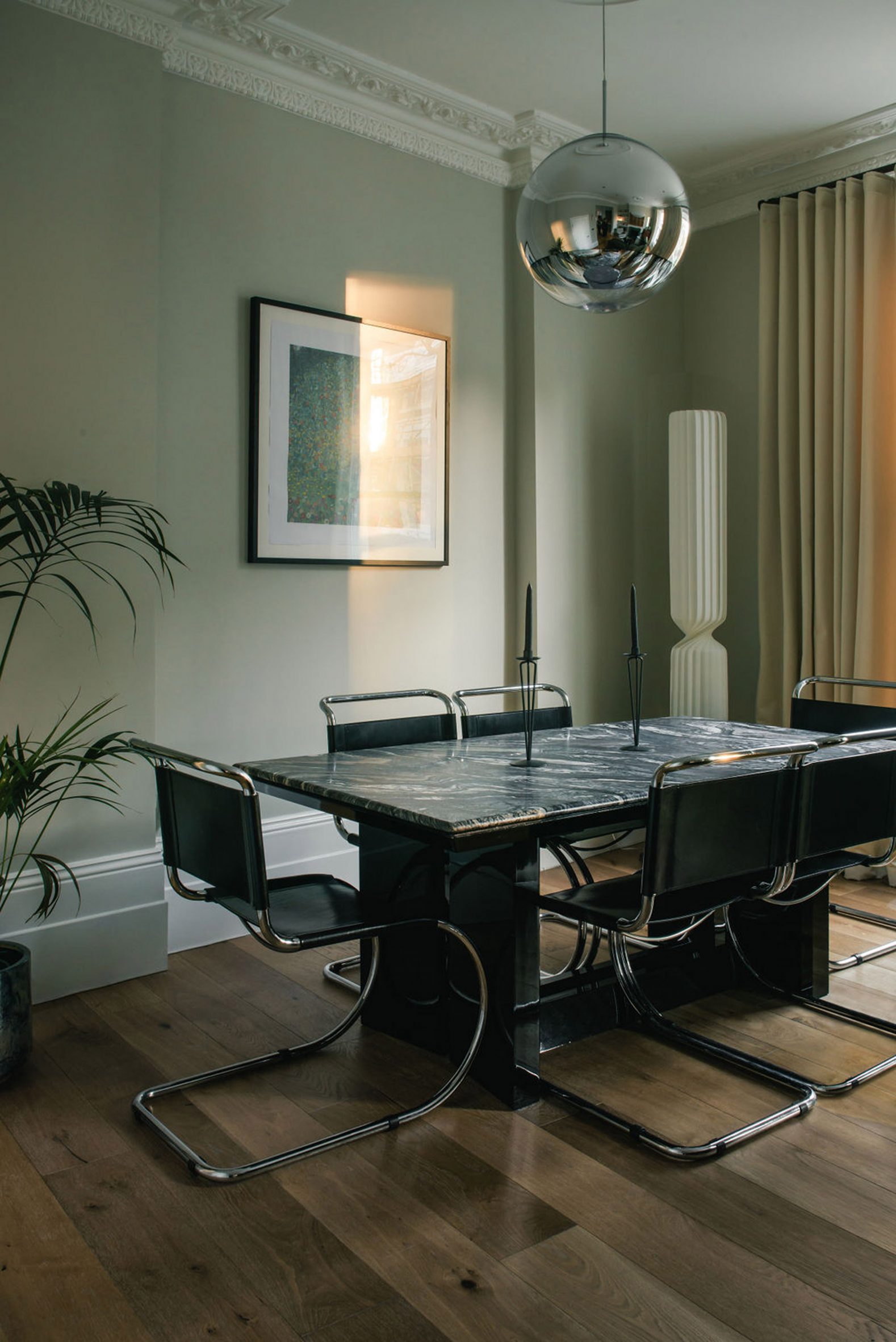 Dining area with stone table surrounded by cantilever chairs