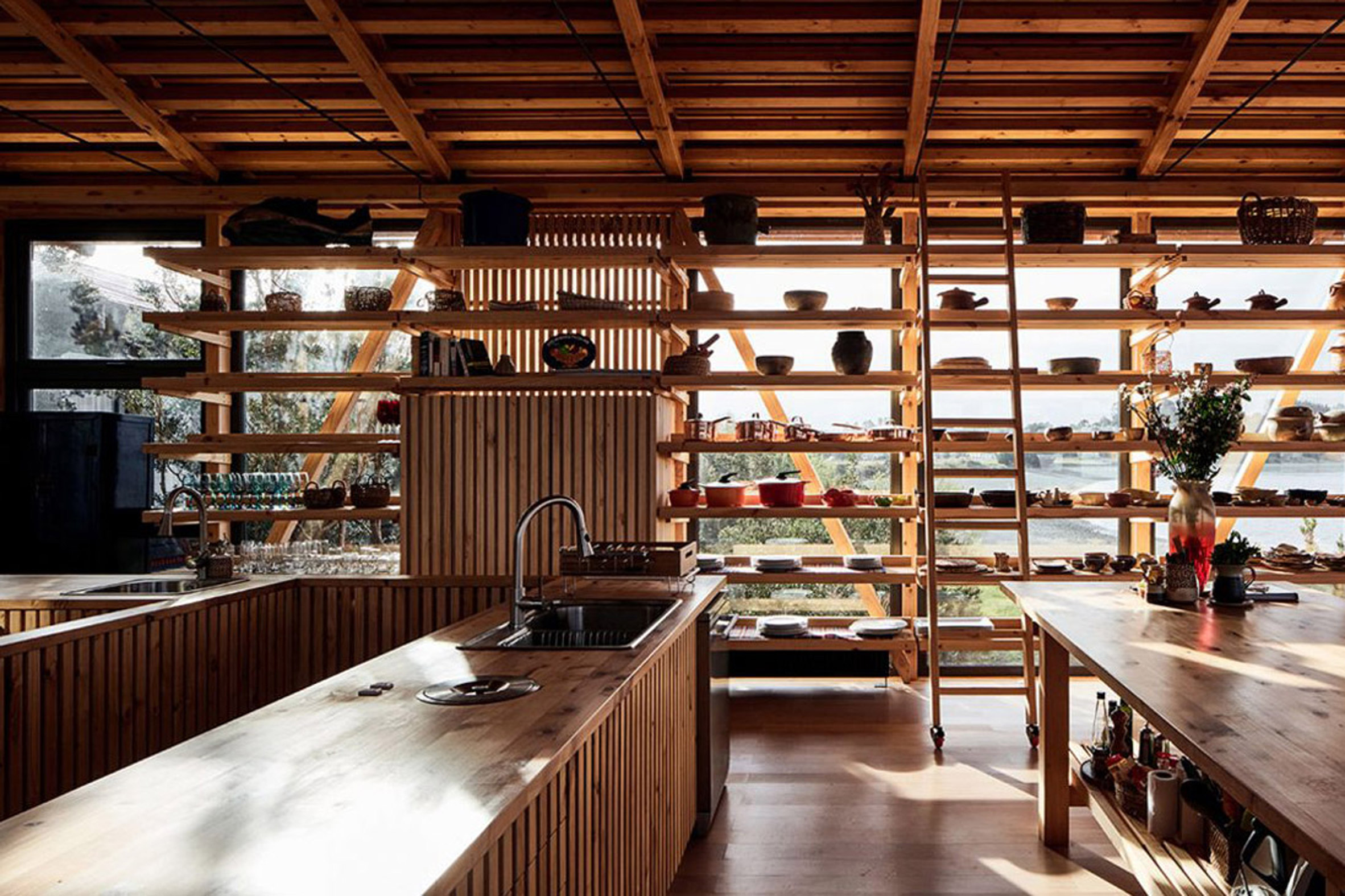 A kitchen with wooden shleving units