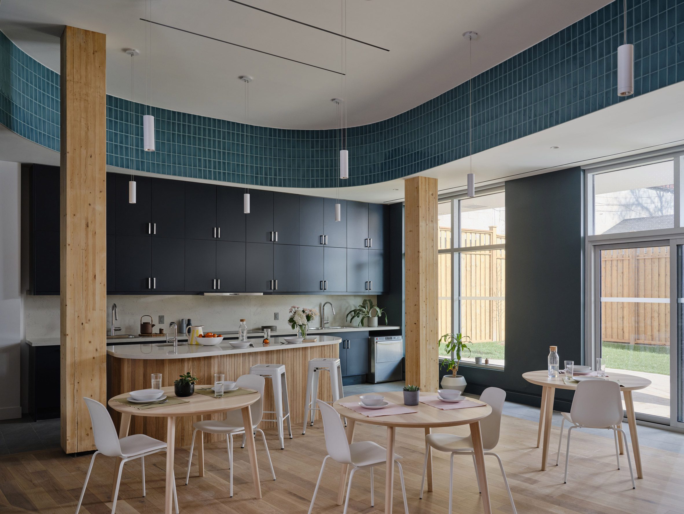 A communal kitchen and dining room with wooden furniture