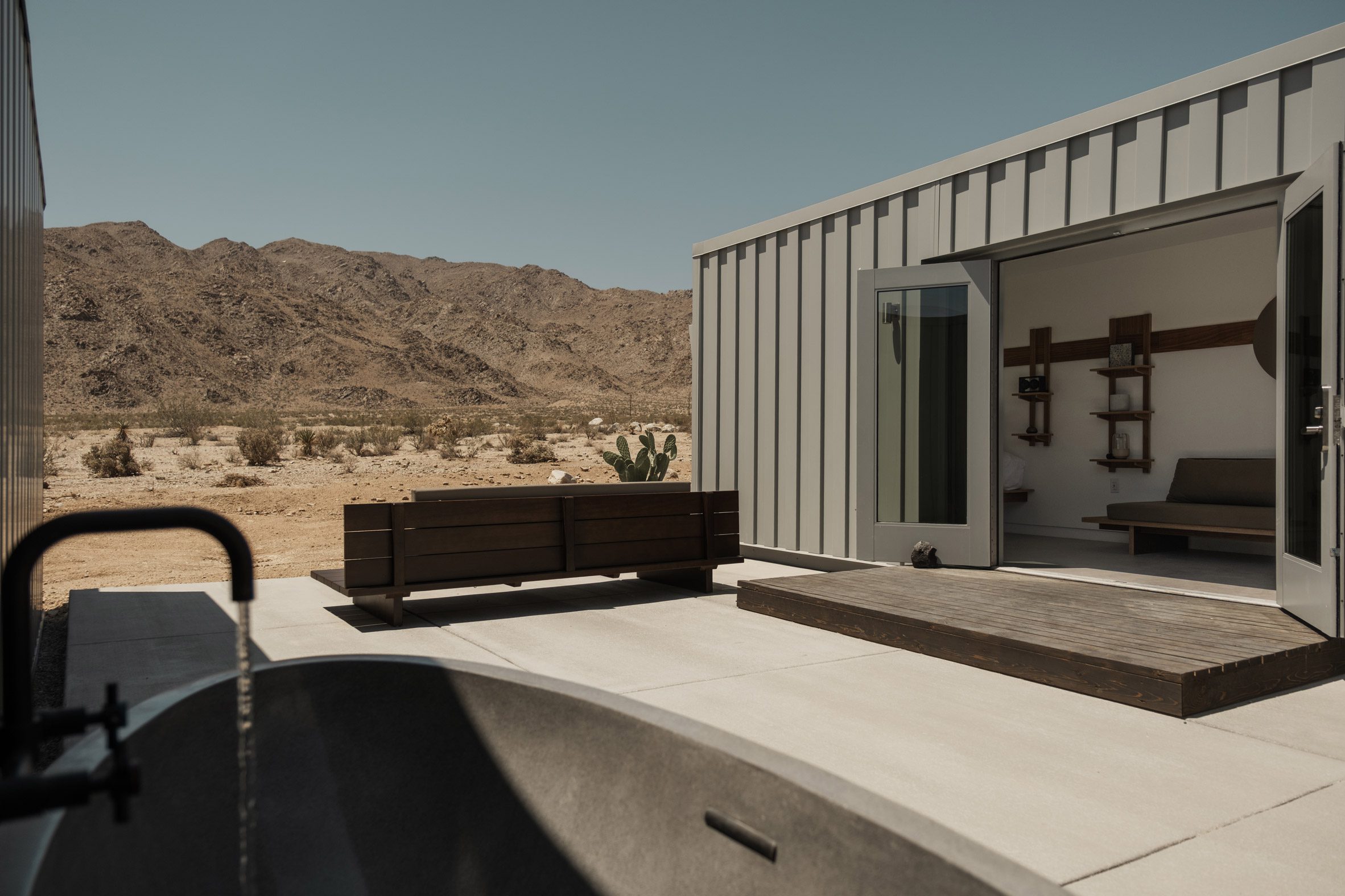 Shipping container hotel room with a patio onto the desert
