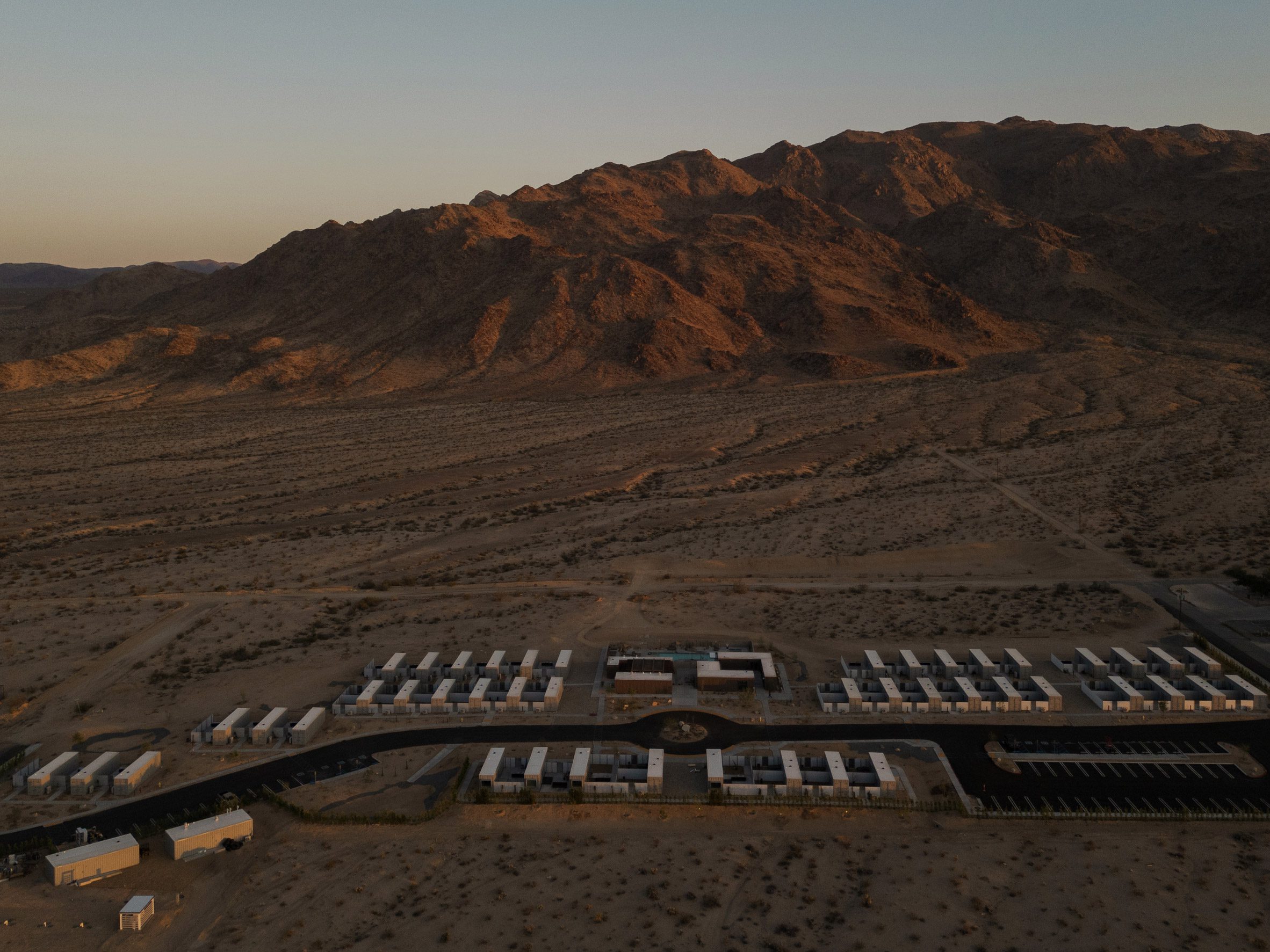 Aerial view of Reset Hotel showing shipping containers close to mountains