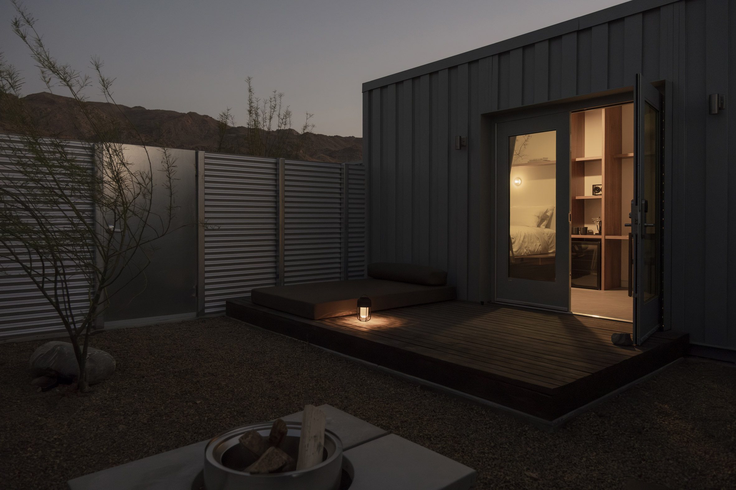 Shipping container room with outdoor patio at night