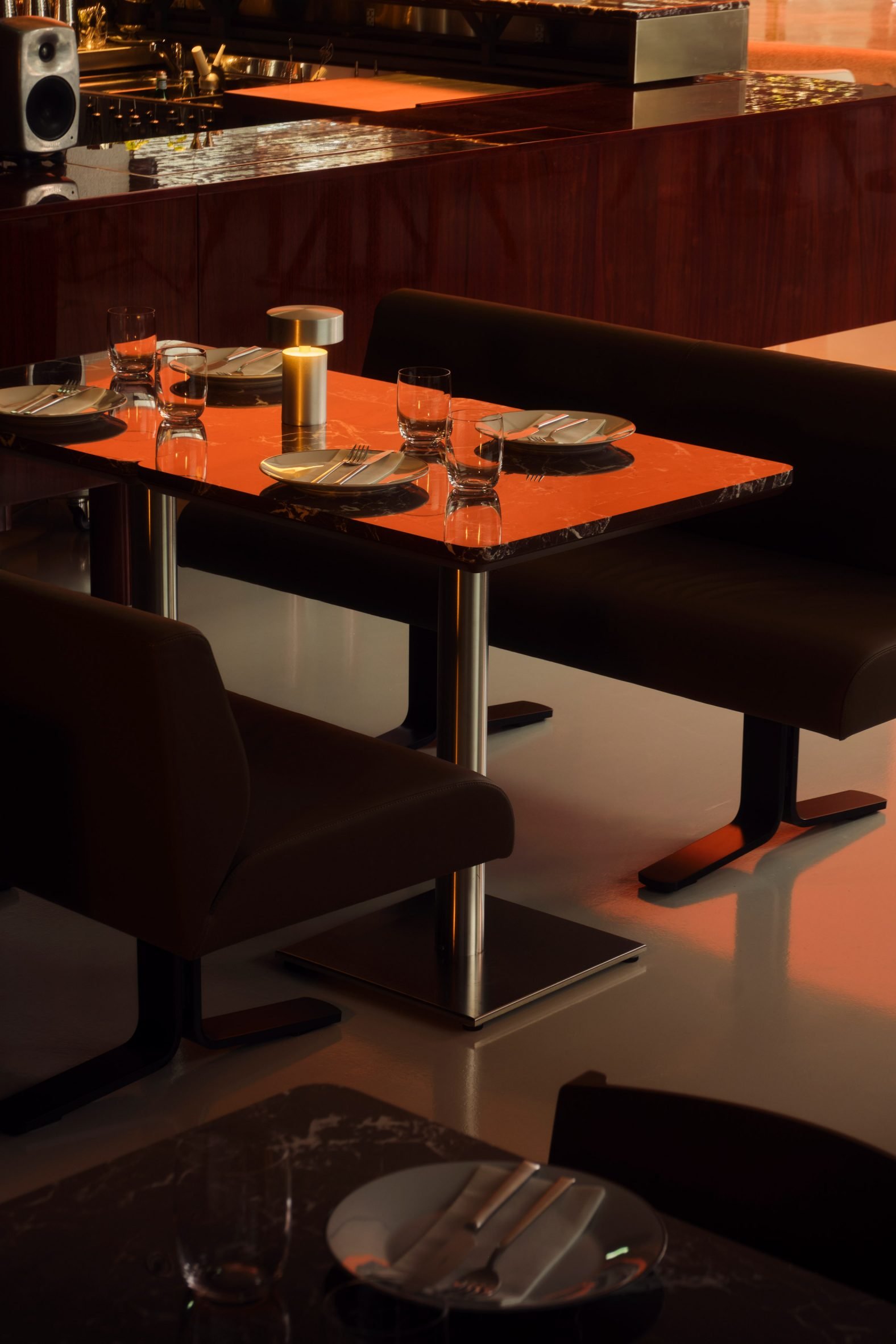 Seating area with high-gloss table inside restaurant